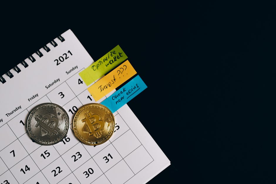 Close-up of Bitcoins on a calendar highlighting investment plans with sticky notes